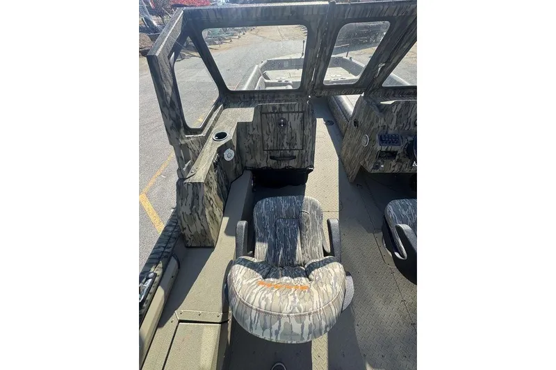 Slide: The Image of 2026 SeaArk EasyCat boat interior with camouflage seating and dashboard. - 19