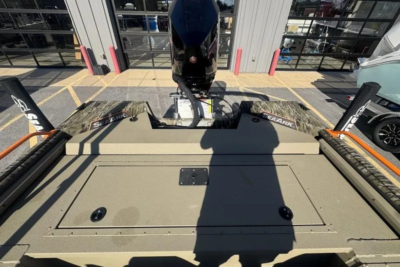 Slide: The Image of 2026 SeaArk EasyCat boat with motor, parked outside a building. - 21