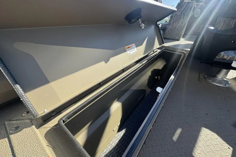 Slide: The Image of 2026 SeaArk EasyCat boat storage compartment with open lid, showcasing interior space. - 24