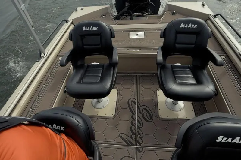 Slide: The Image of 2026 SeaArk EasyCat boat interior with four black seats on a hexagonal-patterned deck. - 30