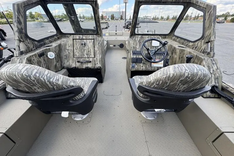 Slide: The Image of 2026 SeaArk EasyCat boat with camouflage design on a trailer, parked outdoors. - 6