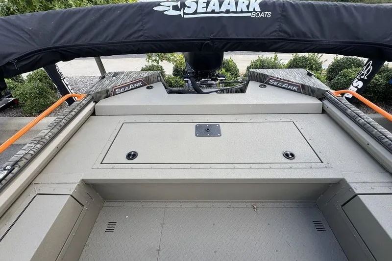 Slide: The Image of 2026 SeaArk EasyCat boat with camouflage design on a trailer, parked outdoors. - 7