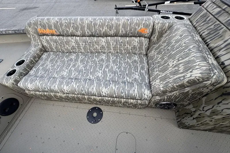 Slide: The Image of Open storage compartment on 2026 SeaArk EasyCat boat with coiled hose inside. - 8