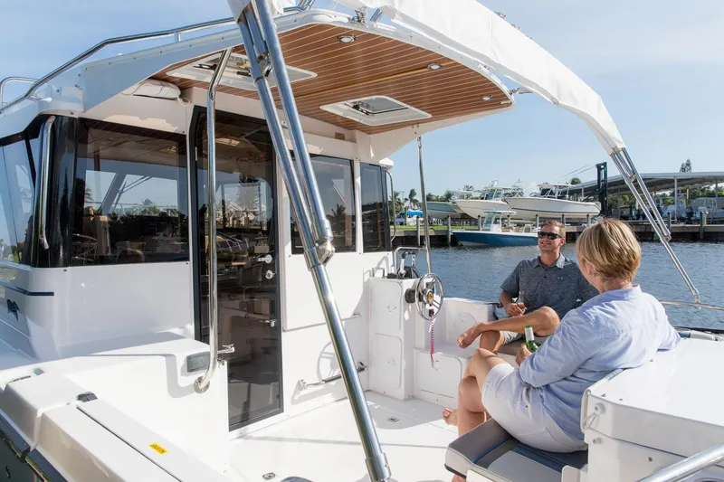 Slide: The Image of Manufacturer Provided Image: 2025 Cutwater C-32 C boat with two people relaxing on deck. - 3