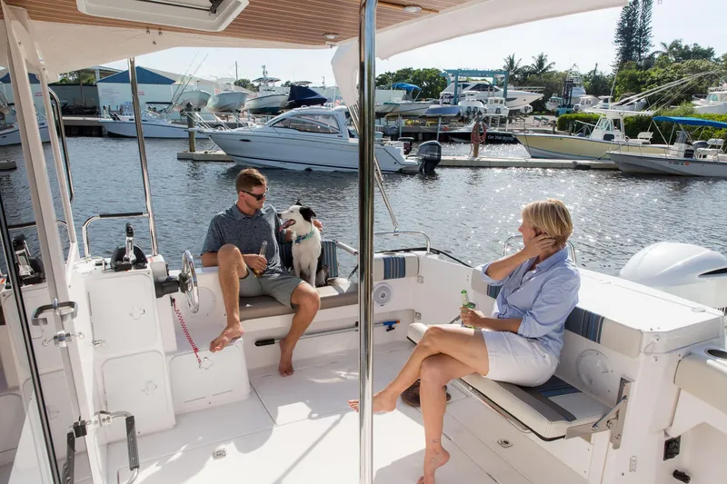 Slide: The Image of Manufacturer Provided Image: Couple relaxing with dog on 2025 Cutwater C-32 C boat at marina. - 4