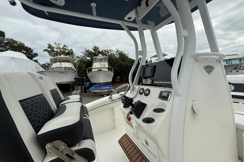 Slide: The Image of 2017 Tidewater 230 LXF boat interior with helm, seating, and control panel. - 14