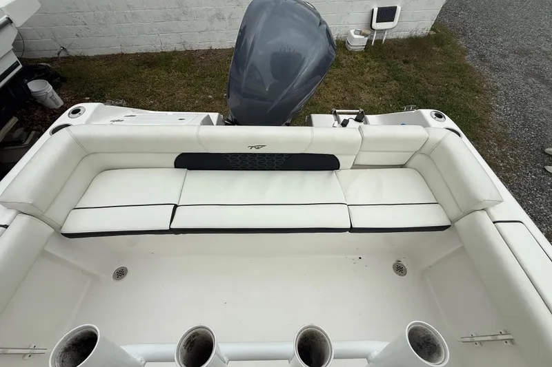 Slide: The Image of 2017 Tidewater 230 LXF boat with white seating and outboard motor. - 15