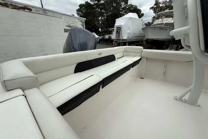 Slide: The Image of 2017 Tidewater 230 LXF boat interior with white seating and outdoor storage. - 18