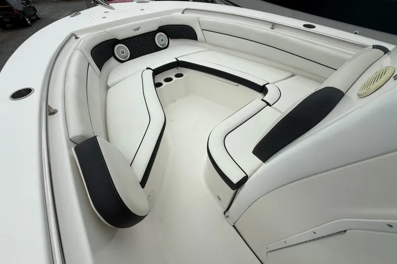 Slide: The Image of 2017 Tidewater 230 LXF boat interior with white cushioned seating and cup holders. - 2