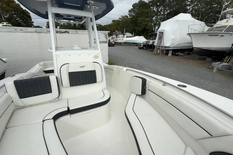 Slide: The Image of 2017 Tidewater 230 LXF boat interior with white seating and storage area. - 26