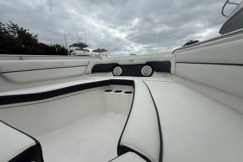Slide: The Image of 2017 Tidewater 230 LXF boat interior with cushioned seating and cup holders. - 5