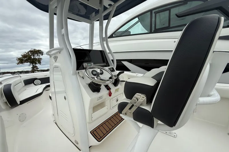 Slide: The Image of 2017 Tidewater 230 LXF boat interior with steering console and seating. - 7