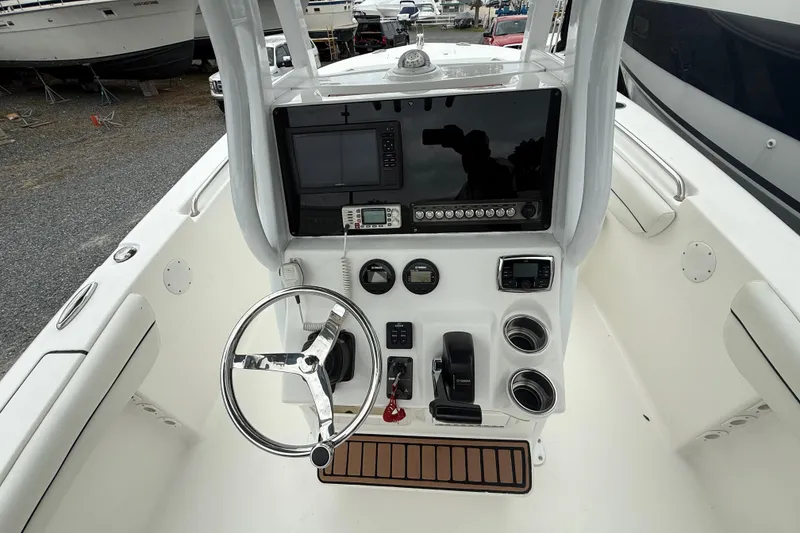 Slide: The Image of 2017 Tidewater 230 LXF boat console with steering wheel and navigation equipment. - 9