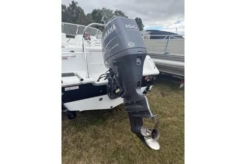 Slide: The Image of 2011 Sea Hunt Escape 207 LE boat with Yamaha 150 outboard motor, parked on grass. - 3