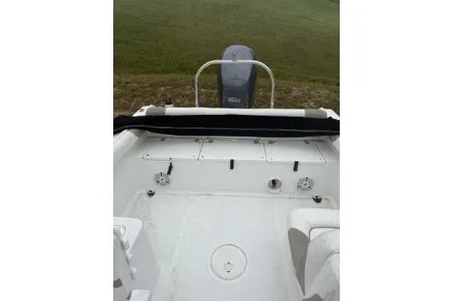 Slide: The Image of 2011 Sea Hunt Escape 207 LE boat interior with motor, white seating, and open deck. - 6