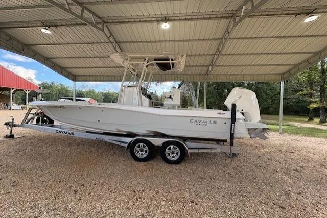 Slide: The Image of 2023 Caymas 26HB boat on trailer under metal canopy, side view. - 0