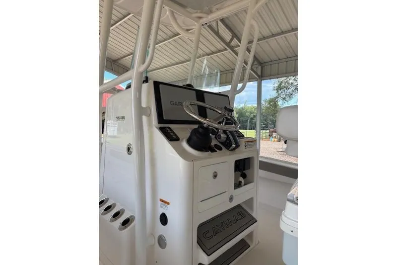 Slide: The Image of 2023 Caymas 26HB boat console with steering wheel and Garmin display. - 3