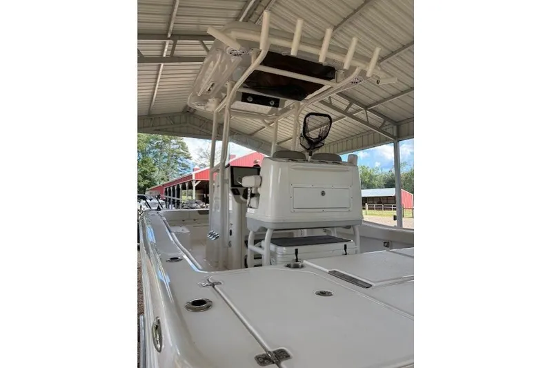 Slide: The Image of 2023 Caymas 26HB boat under a metal canopy, showcasing its sleek design and features. - 4