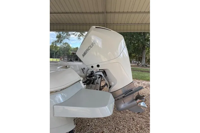 Slide: The Image of 2023 Caymas 26HB boat with Mercury outboard motor under a shelter. - 5