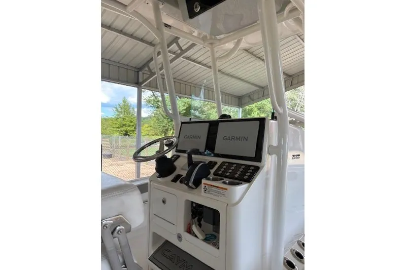 Slide: The Image of 2023 Caymas 26HB boat console with Garmin navigation displays and steering wheel. - 6