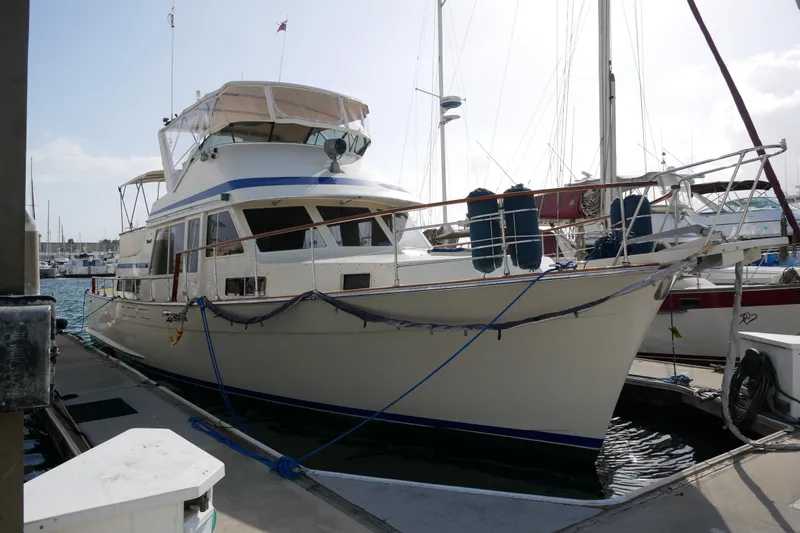 Slide: The Image of 1985 Tollycraft 48 Cockpit Motor Yacht docked at marina, side view. - 0