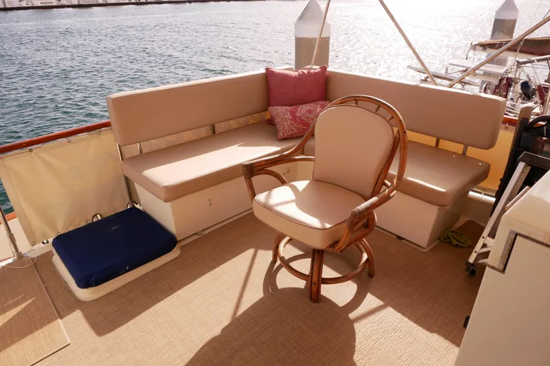 Slide: The Image of 1985 Tollycraft 48 Cockpit Motor Yacht interior with seating area and ocean view. - 13