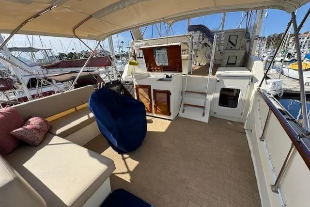 Slide: The Image of 1985 Tollycraft 48 Cockpit Motor Yacht interior with seating, helm, and marina view. - 14