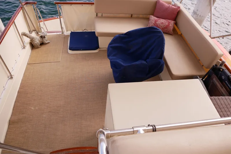 Slide: The Image of 1985 Tollycraft 48 Cockpit Motor Yacht interior with seating and cushions. - 15