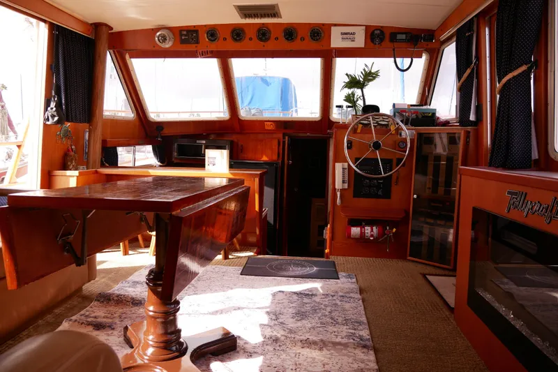 Slide: The Image of Interior of 1985 Tollycraft 48 Cockpit Motor Yacht with wooden furnishings and steering wheel. - 16