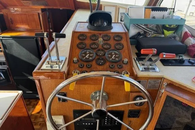 Slide: The Image of 1985 Tollycraft 48 Cockpit Motor Yacht helm with gauges and controls. - 17