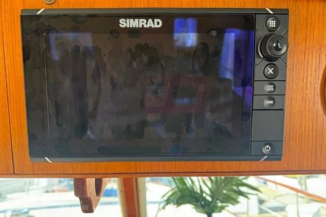 Slide: The Image of Simrad navigation system on 1985 Tollycraft 48 Cockpit Motor Yacht dashboard. - 19