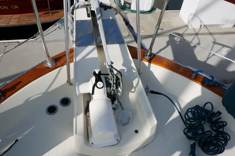Slide: The Image of 1985 Tollycraft 48 Cockpit Motor Yacht deck with anchor winch and coiled rope. - 2