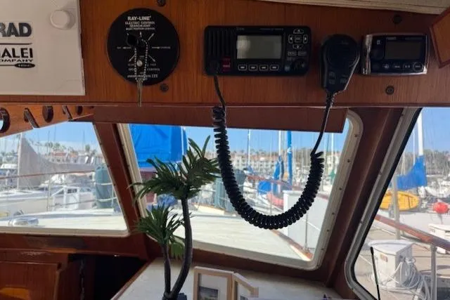 Slide: The Image of 1985 Tollycraft 48 Cockpit Motor Yacht interior with navigation equipment and marina view. - 20