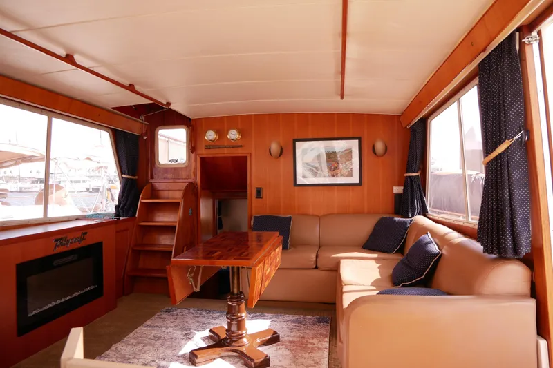 Slide: The Image of Interior of 1985 Tollycraft 48 Cockpit Motor Yacht with cozy seating and wooden accents. - 36
