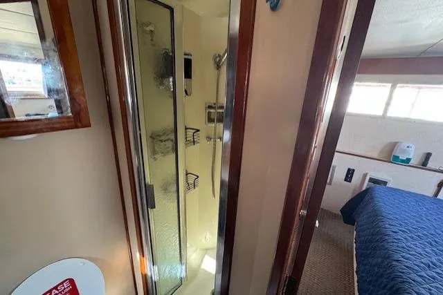 Slide: The Image of 1985 Tollycraft 48 Cockpit Motor Yacht interior with shower and bedroom view. - 42