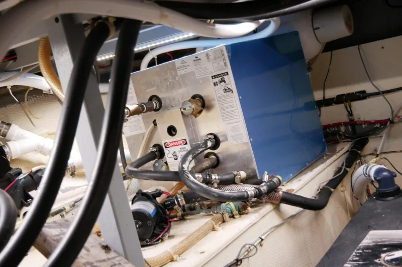 Slide: The Image of Engine room of 1985 Tollycraft 48 Cockpit Motor Yacht with visible machinery and wiring. - 45