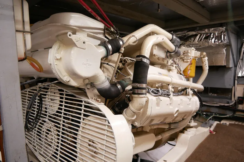 Slide: The Image of Engine room of 1985 Tollycraft 48 Cockpit Motor Yacht, showcasing detailed machinery components. - 48