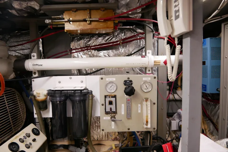 Slide: The Image of Engine room of 1985 Tollycraft 48 Cockpit Motor Yacht with gauges and equipment. - 52
