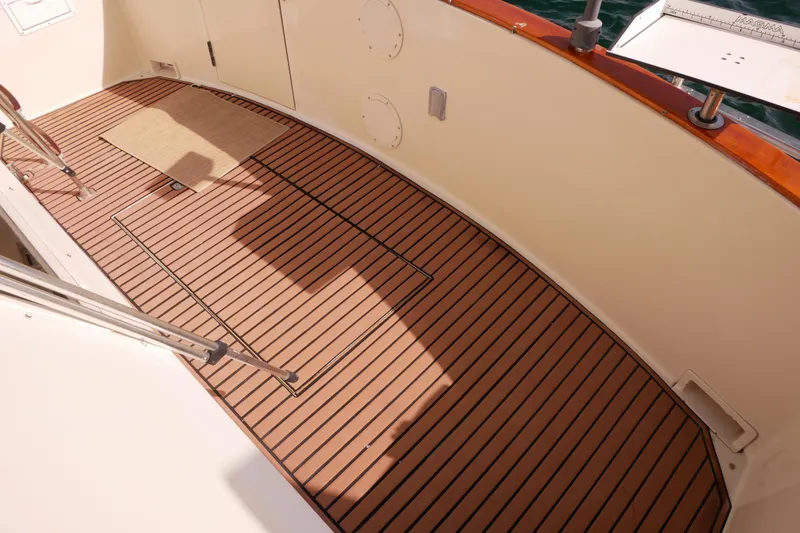 Slide: The Image of 1985 Tollycraft 48 Cockpit Motor Yacht deck with teak flooring and railing. - 6