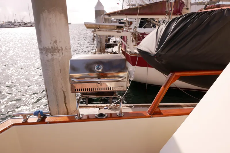Slide: The Image of 1985 Tollycraft 48 Cockpit Motor Yacht with stainless steel grill at marina. - 8