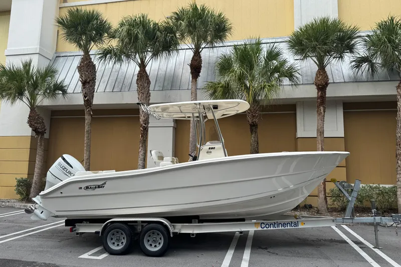 The Image of 2026 Bulls Bay 230 Center Console boat on trailer, parked near palm trees. - 0