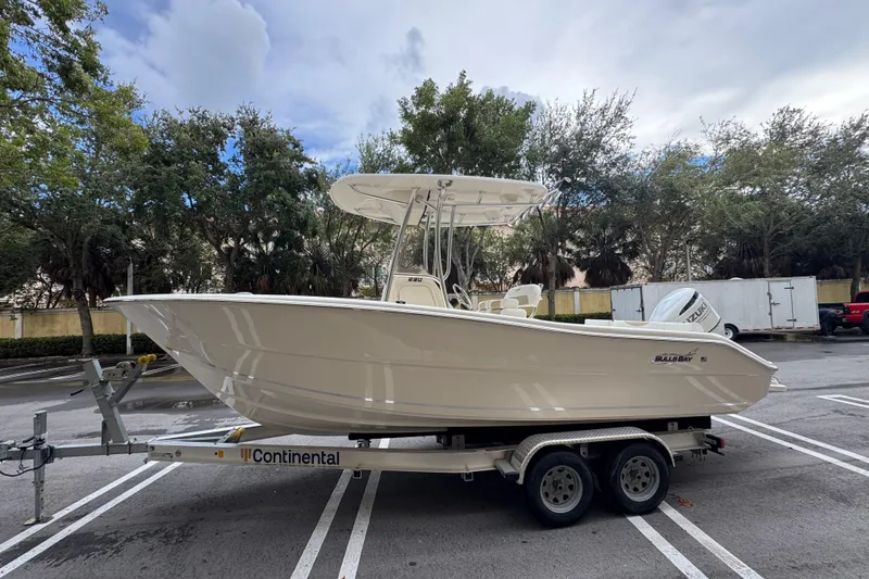 Slide: The Image of 2026 Bulls Bay 230 Center Console boat on trailer in parking lot. - 1