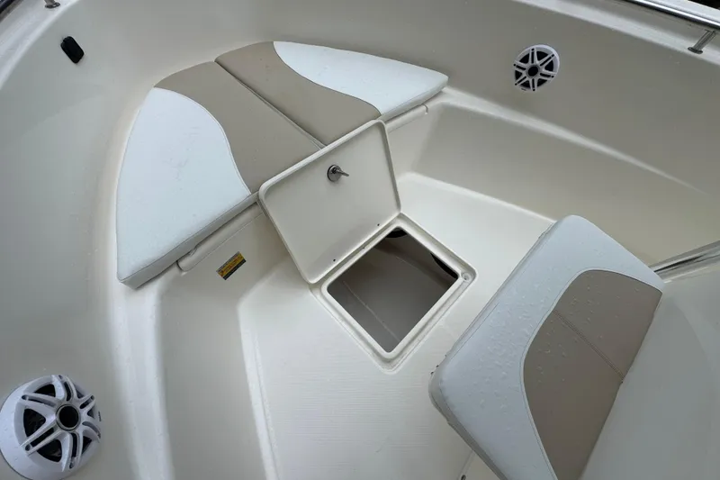 Slide: The Image of 2026 Bulls Bay 230 Center Console boat interior with storage compartment and cushioned seating. - 12