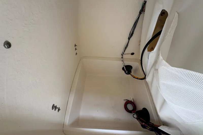 Slide: The Image of Interior compartment of 2026 Bulls Bay 230 Center Console boat, showing wiring and storage space. - 15