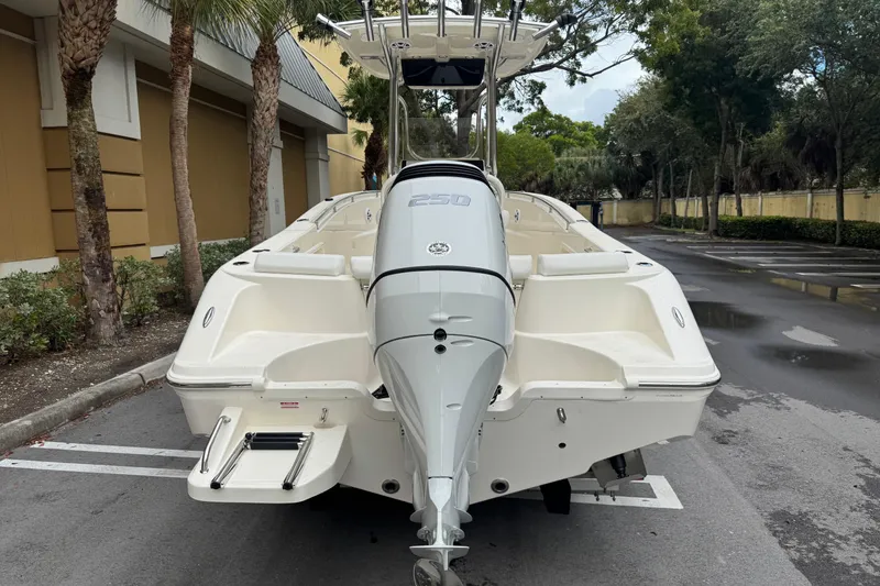 Slide: The Image of 2026 Bulls Bay 230 Center Console boat, rear view in a parking lot. - 2