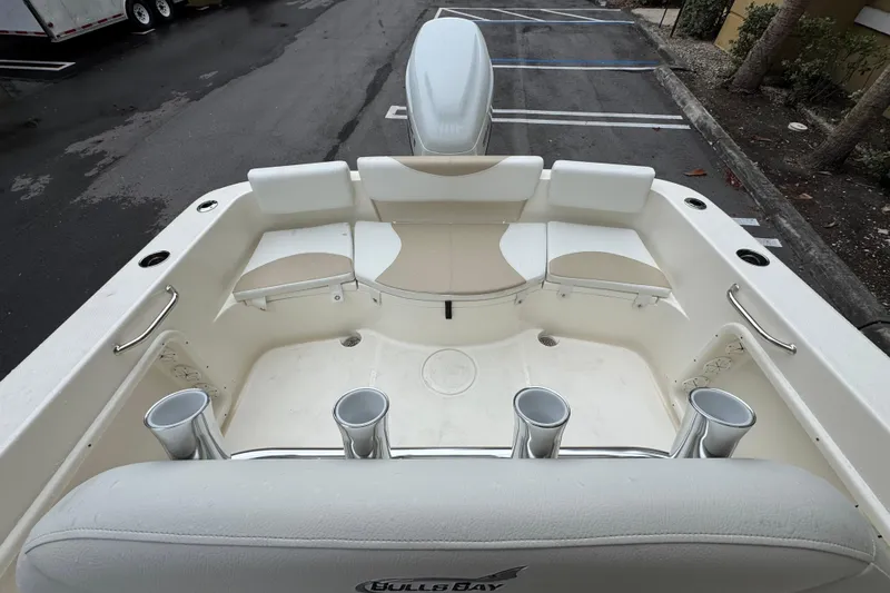 Slide: The Image of 2026 Bulls Bay 230 Center Console boat interior with seating and rod holders. - 7