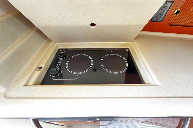 Slide: The Image of Built-in stovetop on 2004 Sea Ray 320 Sundancer yacht kitchen counter. - 10