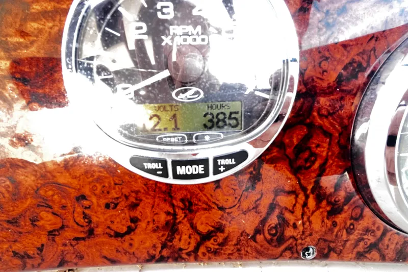 Slide: The Image of Dashboard of 2004 Sea Ray 320 Sundancer showing RPM gauge and digital display. - 14