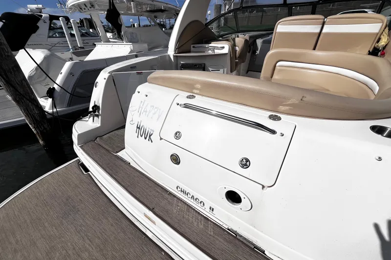 Slide: The Image of 2004 Sea Ray 320 Sundancer docked, featuring beige seating and "Happy Hour" text. - 15