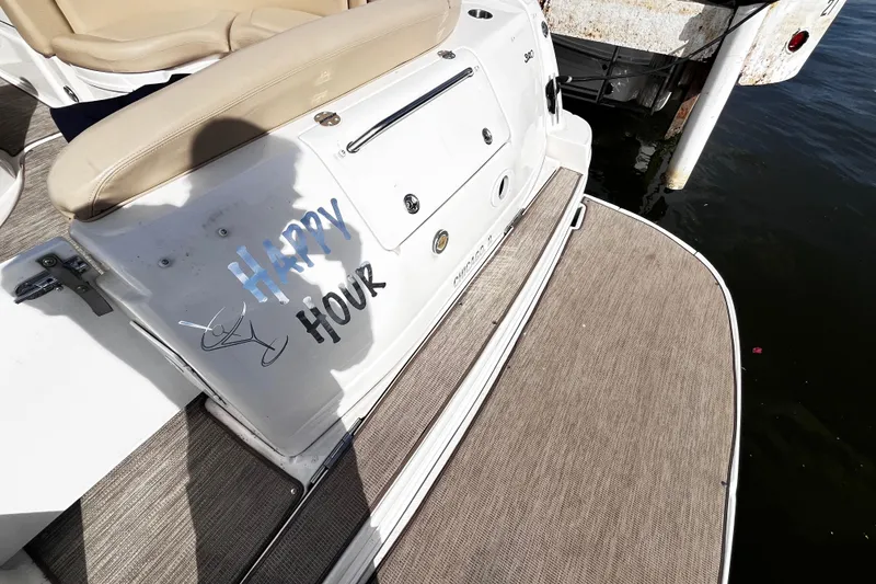 Slide: The Image of 2004 Sea Ray 320 Sundancer boat with "Happy Hour" text on deck. - 17